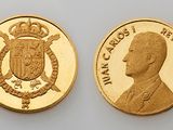 a close up of two gold coins on a white surface