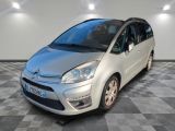 the small silver car is parked on a checkered tile floor