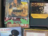 many cd ' s and cds in a box on the floor