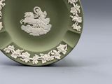 a green plate with a picture of a horse and a bird on it