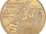 a close up of a gold medal with a star on it