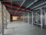 the inside of a large warehouse with scaffolding and red pipes