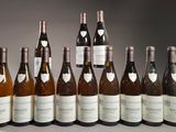 six bottles of wine are lined up in a row on a table