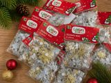 a pile of christmas crackers sitting on a table next to a christmas tree