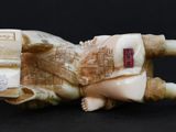 a figurine of a man laying on a book