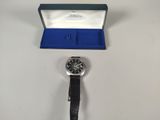 a close up of a watch in a box on a table