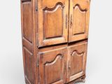 an old wooden cabinet with two doors and a drawer underneath it