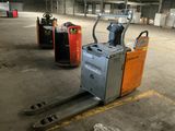 two forklifts that are parked in a warehouse