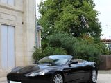a black sports car parked in front of a house