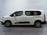 the white van is parked on the concrete floor in the room