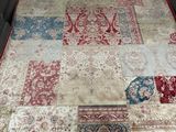 a large patchwork rug on the floor in a room