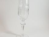 a clear wine glass sitting on a white surface