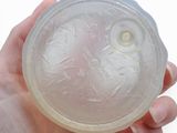 a person holding a plastic object in their hand
