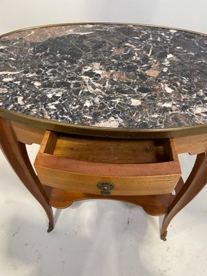 une table avec un plateau en marbre et un tiroir en dessous