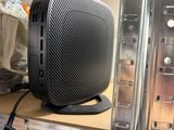 a black speaker sitting on top of a metal shelf