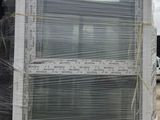 a picture of a window in a building with a sky background