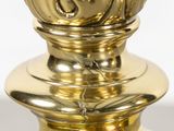 a gold vase that is sitting on top of a table