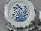 pair of blue and white plates with flowers and birds on them