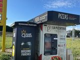 a vending machine in the middle of a parking lot