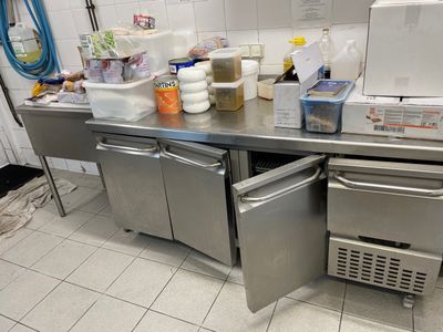 a stainless steel counter with a refrigerator and freezer on it