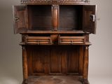 an old wooden cabinet with a door open on top of it