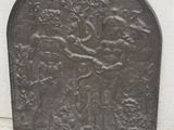 a metal door with a design on it on the sidewalk