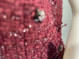 a close up of a red dress with sequins on it