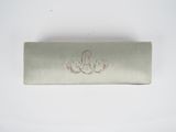 a silver box with a drawing on it on a white surface