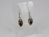 a pair of silver earrings with garnets on them
