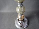a silver vase with two balls on top of it
