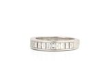 a close up of a white gold ring with baguets of diamonds