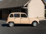 a small tan car parked in front of a building