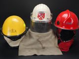 three different types of fire helmets on a black background