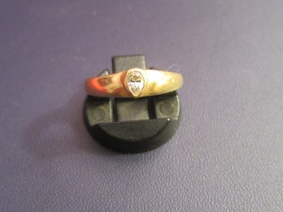 a gold ring with a diamond on top of it