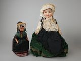 two dolls of a woman and a man sitting next to each other