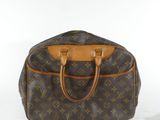 a close up of a louis vuitton handbag on a white surface