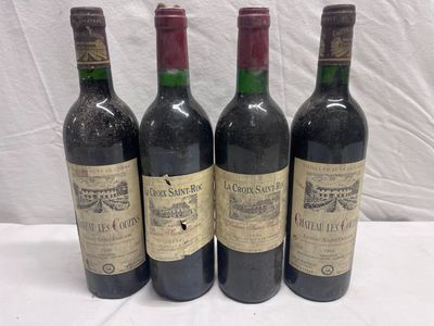 four bottles of wine are lined up on a table