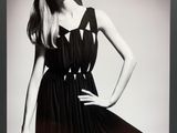 black and white photograph of a woman in a dress posing for a picture