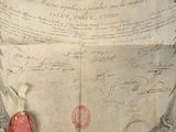 an old document with a red wax seal on it