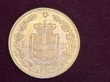 a close up of a gold coin on a purple surface