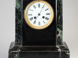 a black and gold clock with roman numerals on it