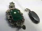 an image of a necklace and a pendant with a green stone on it