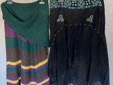 two skirts hanging on a clothes rack with a scarf on it
