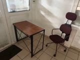 a desk and chair in a room with a window