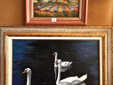 two paintings of swans on the wall next to each other