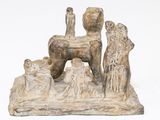 a statue of a dog and a cat on a rock