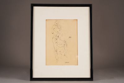 a drawing of a nude woman in a black frame on a table