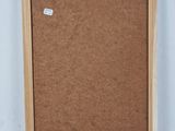 an old picture frame with a cork board attached to it