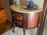 une petite table sur laquelle se trouve un vase bleu