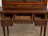 a wooden desk with two drawers and a glass door